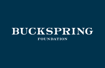 Logo of the Buckspring Foundation, featuring the organization's name in bold, white, capitalized serif font on a dark blue background. The word 'Foundation' is centered below 'Buckspring' in smaller, white, capitalized letters.